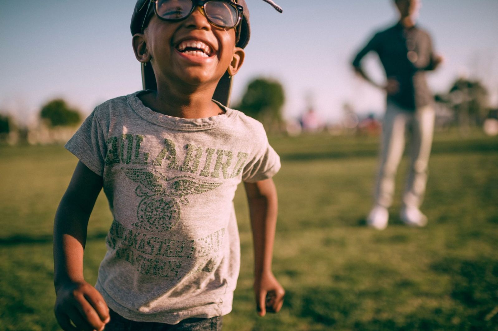 Child laughing joyfully outdoors
